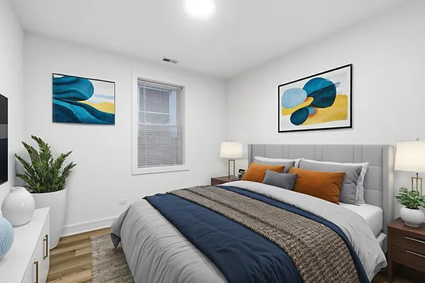 a bedroom with a bed and a painting on the wall