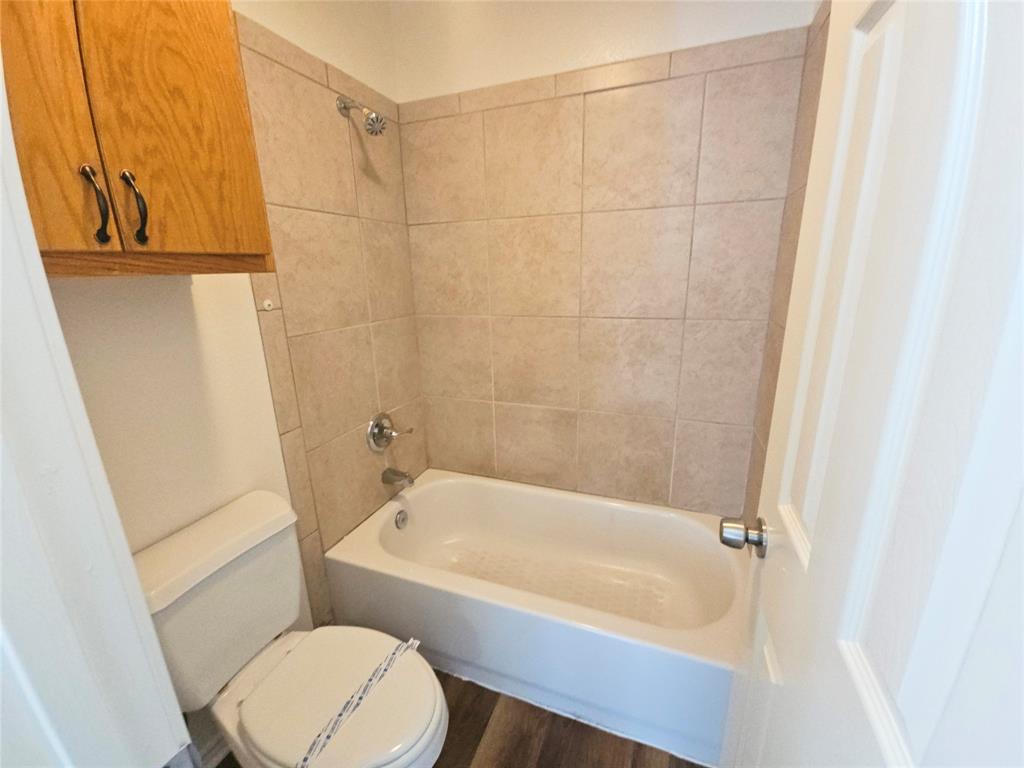 508 East Denton Drive Euless, TX 76039 - Photo 18 of 22 a bathroom with a bathtub and a toilet