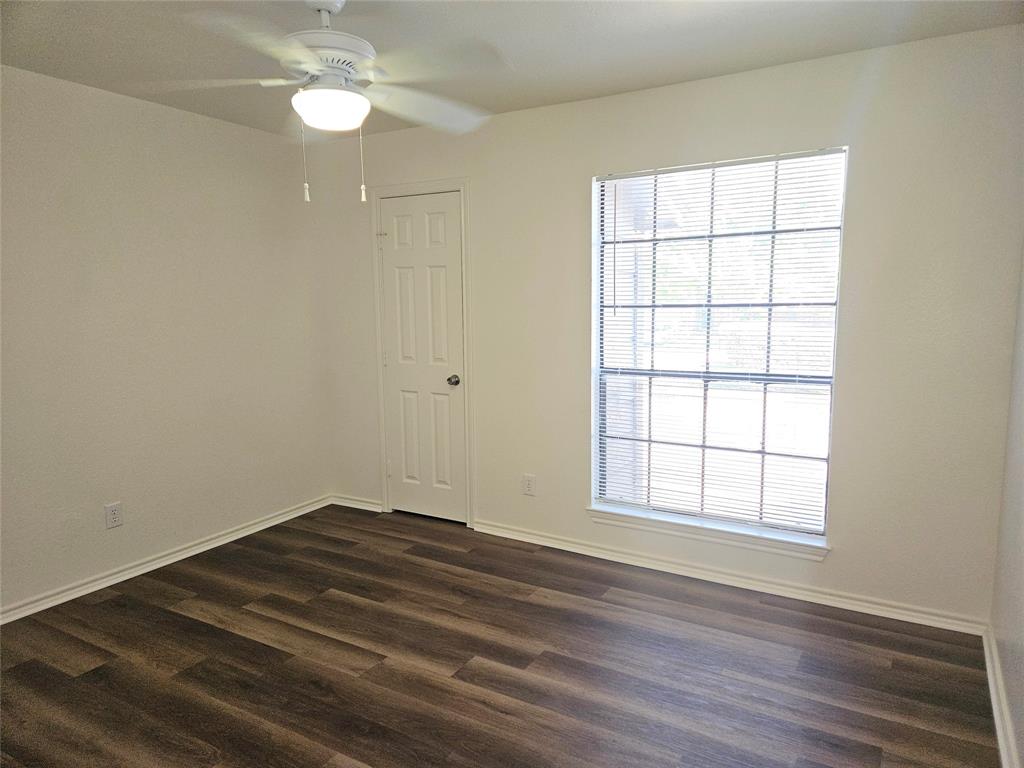 508 East Denton Drive Euless, TX 76039 - Photo 20 of 22 an empty room with wooden floor and windows
