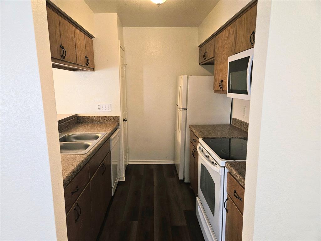 508 East Denton Drive Euless, TX 76039 - Photo 9 of 22 a kitchen with a stove microwave and refrigerator