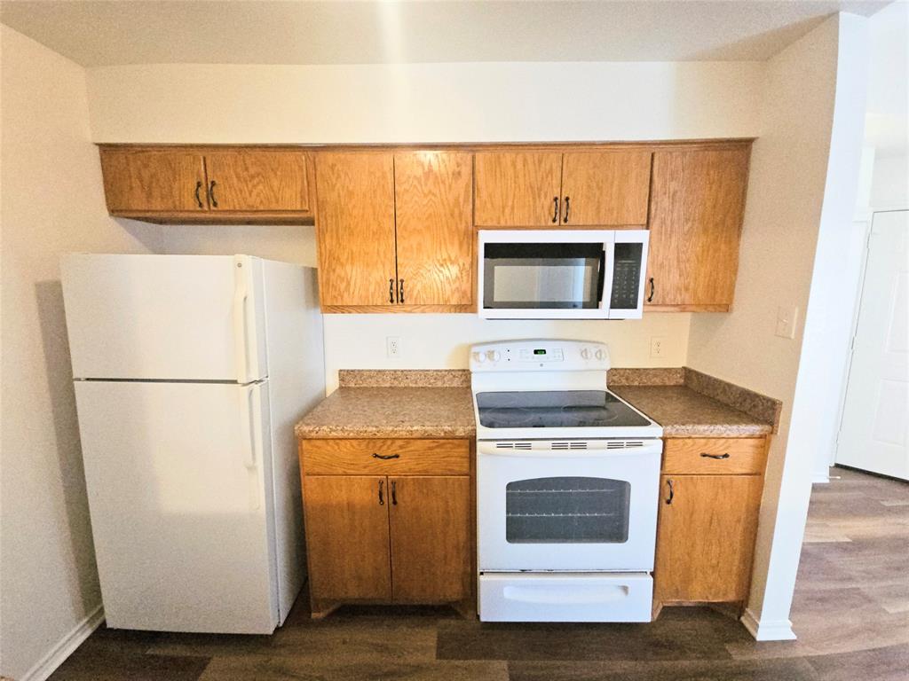 508 East Denton Drive Euless, TX 76039 - Photo 10 of 22 a kitchen with a stove top oven and refrigerator