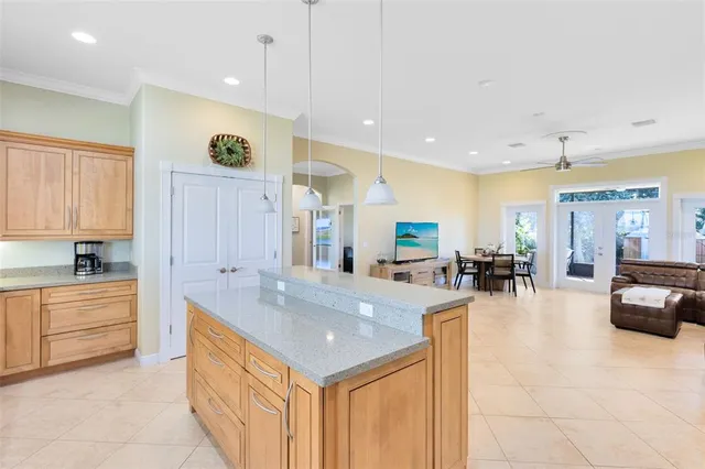 a large kitchen with a large counter top appliances and cabinets