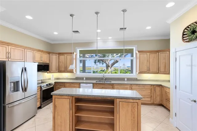 a kitchen with stainless steel appliances a stove a refrigerator and a sink