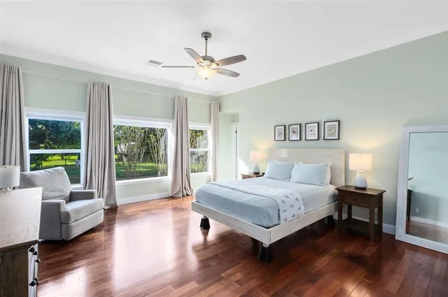 a bedroom with a bed and a large window