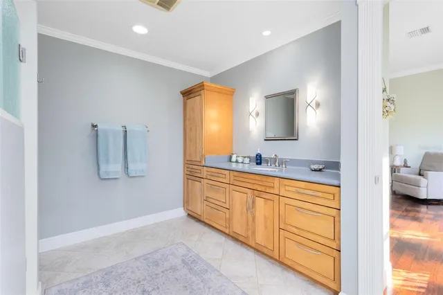 a spacious bathroom with a double vanity sink and a mirror
