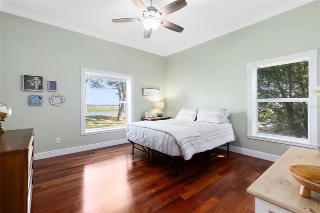 a spacious bedroom with a bed and a window