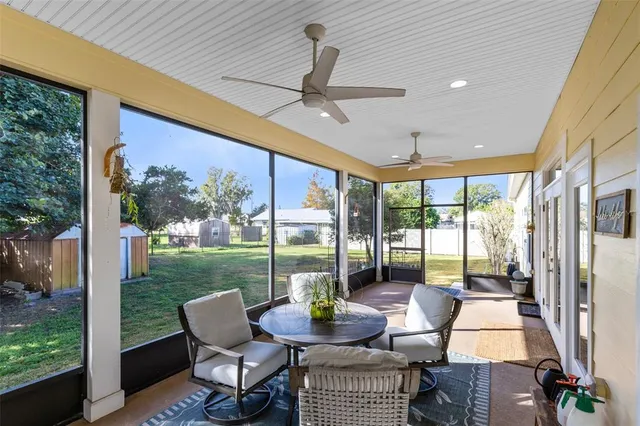 a view of a patio with a dining table chairs and backyard