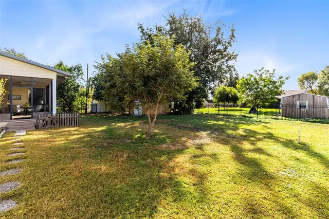a view of a swimming pool with an outdoor seating and a yard