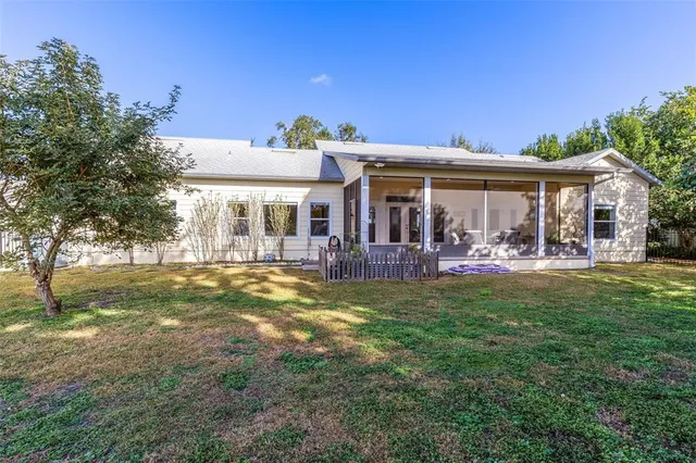 a view of a house with a backyard porch and sitting area
