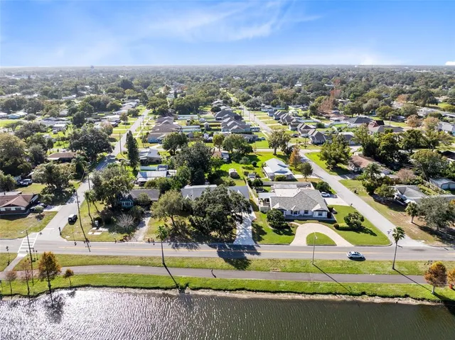 an aerial view of residential houses with outdoor space and parking