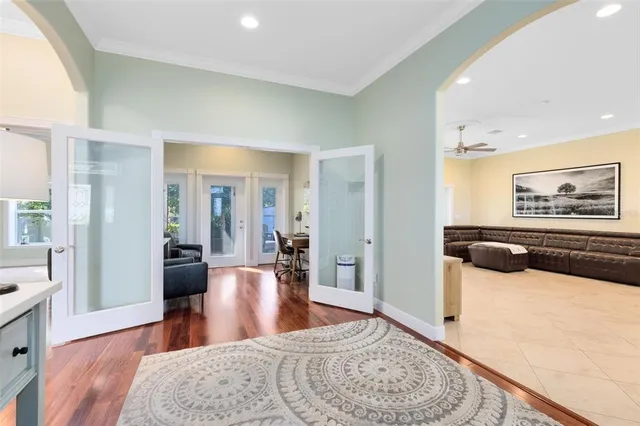 a living room with furniture wooden floor and a large window