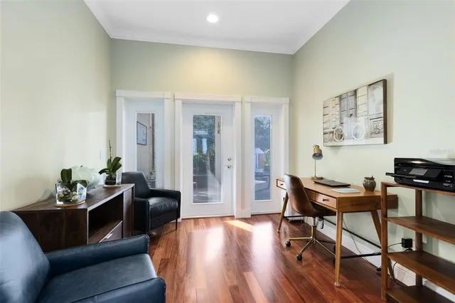 a living room with furniture and wooden floor