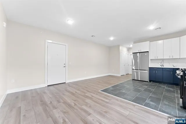 a view of kitchen with wooden floor electronic appliances and window