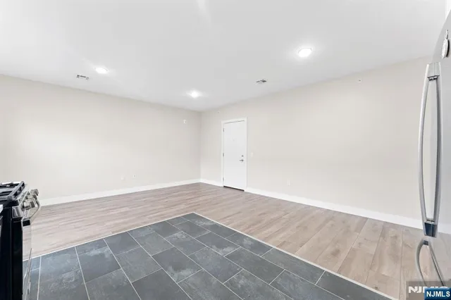 an empty room with wooden floor