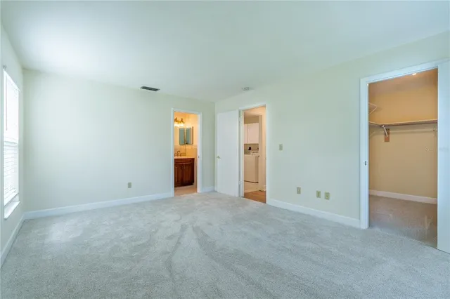 an empty room with closet and mirror