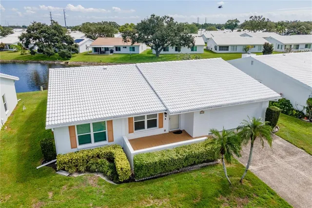 a aerial view of a house with a yard table and chairs