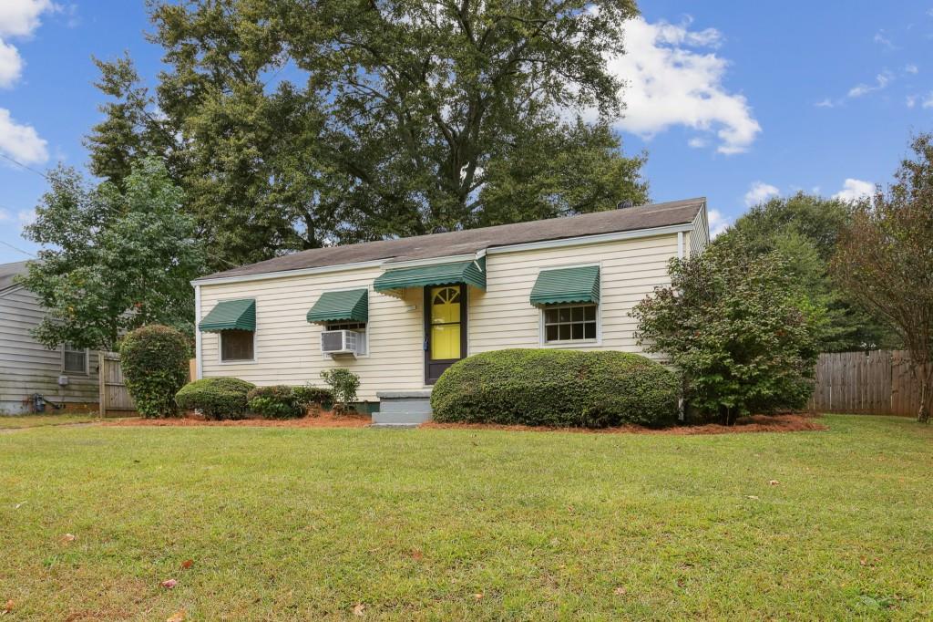2046 Idlewood Road Tucker, GA 30084 - Photo 1 of 1 a front view of house with yard and trees in the background