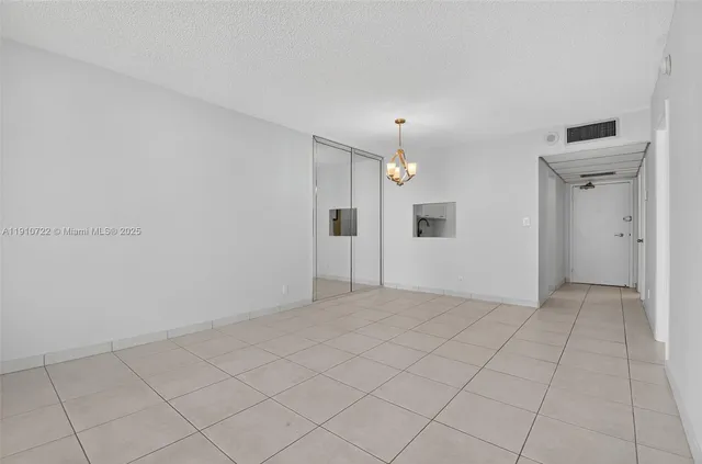 an empty room with entrance and shower