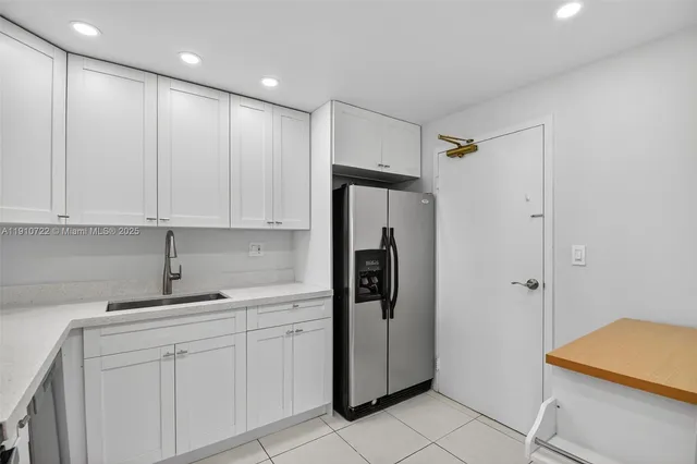 a kitchen with a sink and refrigerator