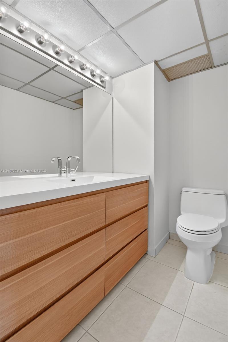 336 North Birch Road, Unit 12B Fort Lauderdale, FL 33304 - Photo 23 of 55 a bathroom with a toilet sink and mirror