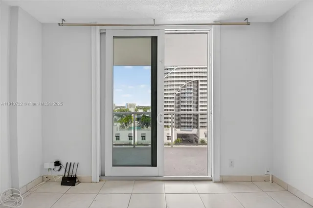 a front view of a building with a garden and plants