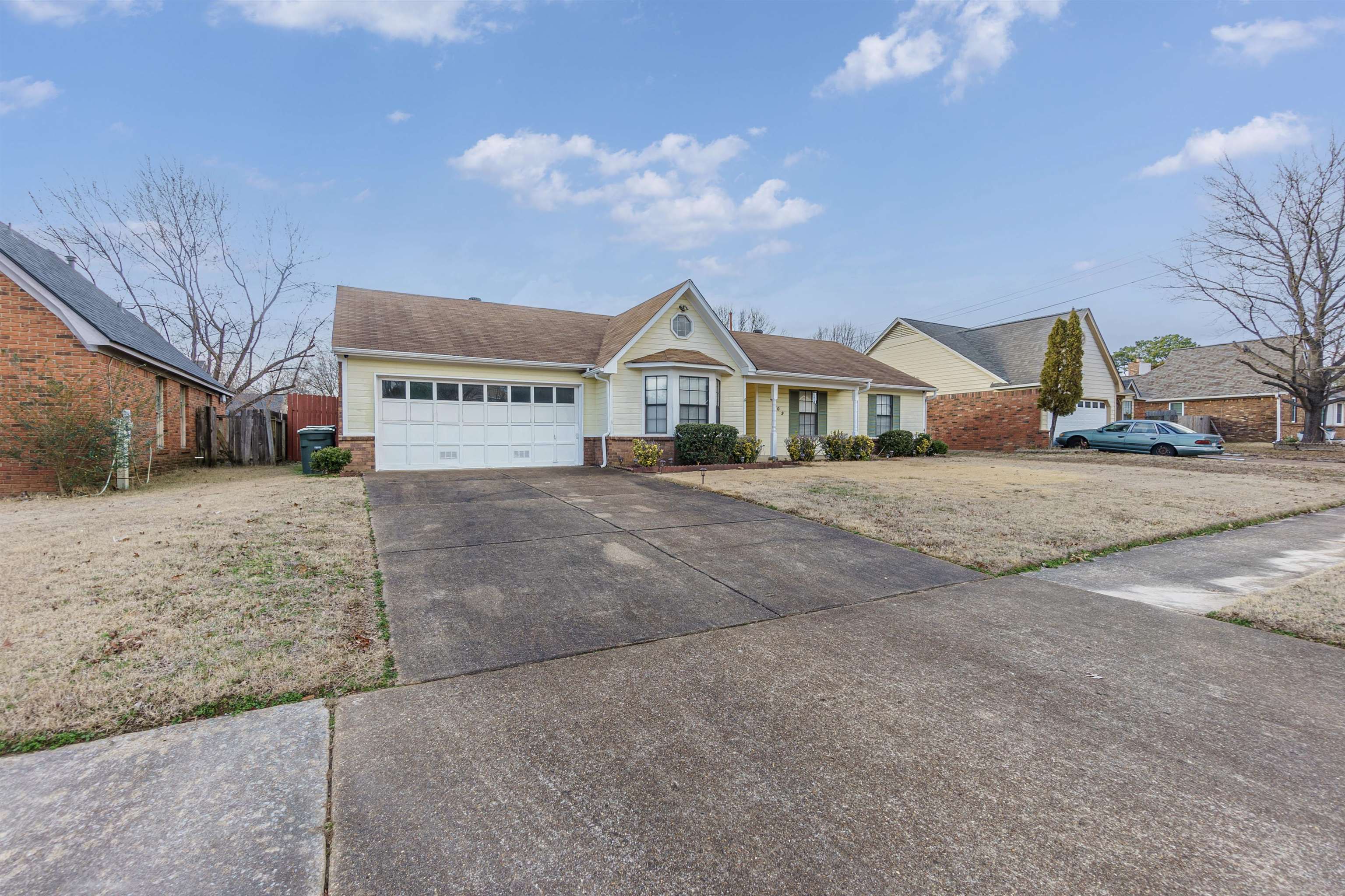 4509 Ross Road Memphis, TN 38141 - Photo 3 of 19 a front view of a house with a yard and garage