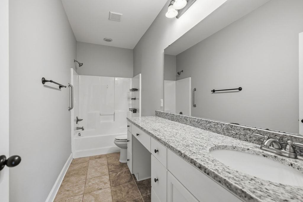 214 Friend Street Anderson, SC 29621 - Photo 24 of 40 This bathroom features a sleek vanity, inviting tub, and ample lighting for a refreshing start to your day.