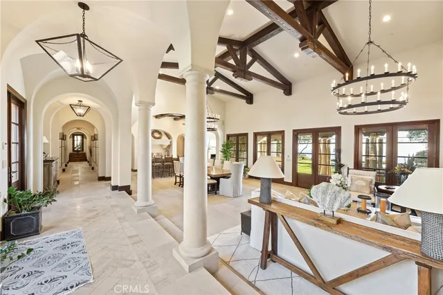 a living room with furniture a fireplace and a chandelier