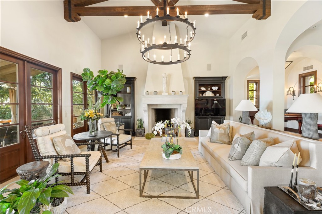 16 Shore Walk Newport Coast, CA 92657 - Photo 14 of 75 a living room with furniture a chandelier and a fireplace