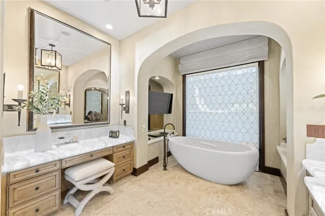 a en suite bathroom with a sink double vanity and a mirror
