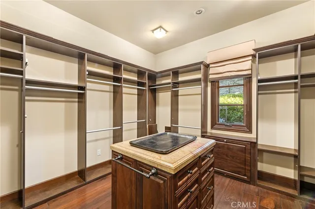 a en suite bathroom with a granite countertop sink and a mirror