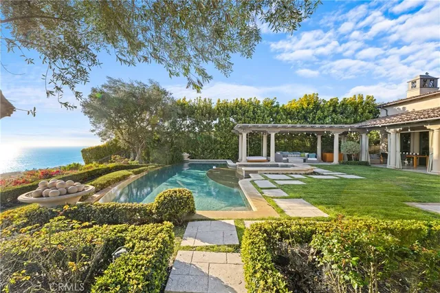 a bedroom with two beds and potted plant