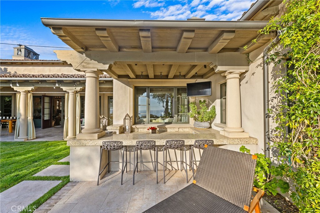 16 Shore Walk Newport Coast, CA 92657 - Photo 39 of 75 a view of a patio with table and chairs and potted plants