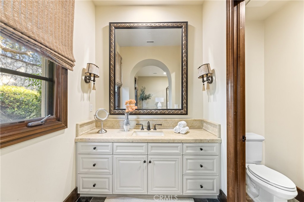 16 Shore Walk Newport Coast, CA 92657 - Photo 48 of 75 a bathroom with a granite countertop sink vanity mirror and toilet