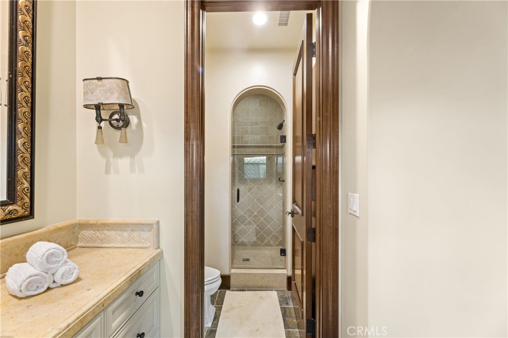 16 Shore Walk Newport Coast, CA 92657 - Photo 49 of 75 a en suite bathroom with a granite countertop sink and a mirror