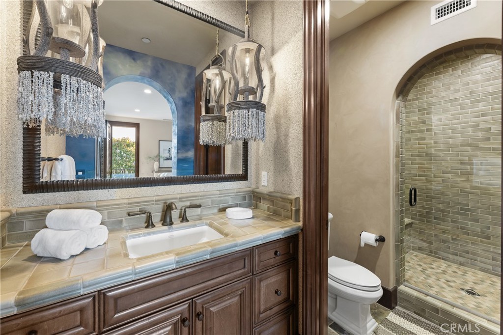 16 Shore Walk Newport Coast, CA 92657 - Photo 58 of 75 a bathroom with a granite countertop sink mirror vanity and toilet