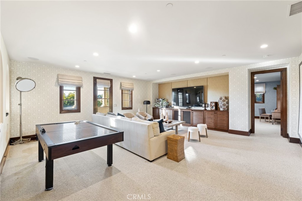 16 Shore Walk Newport Coast, CA 92657 - Photo 60 of 75 a living room with furniture a table and a flat screen tv