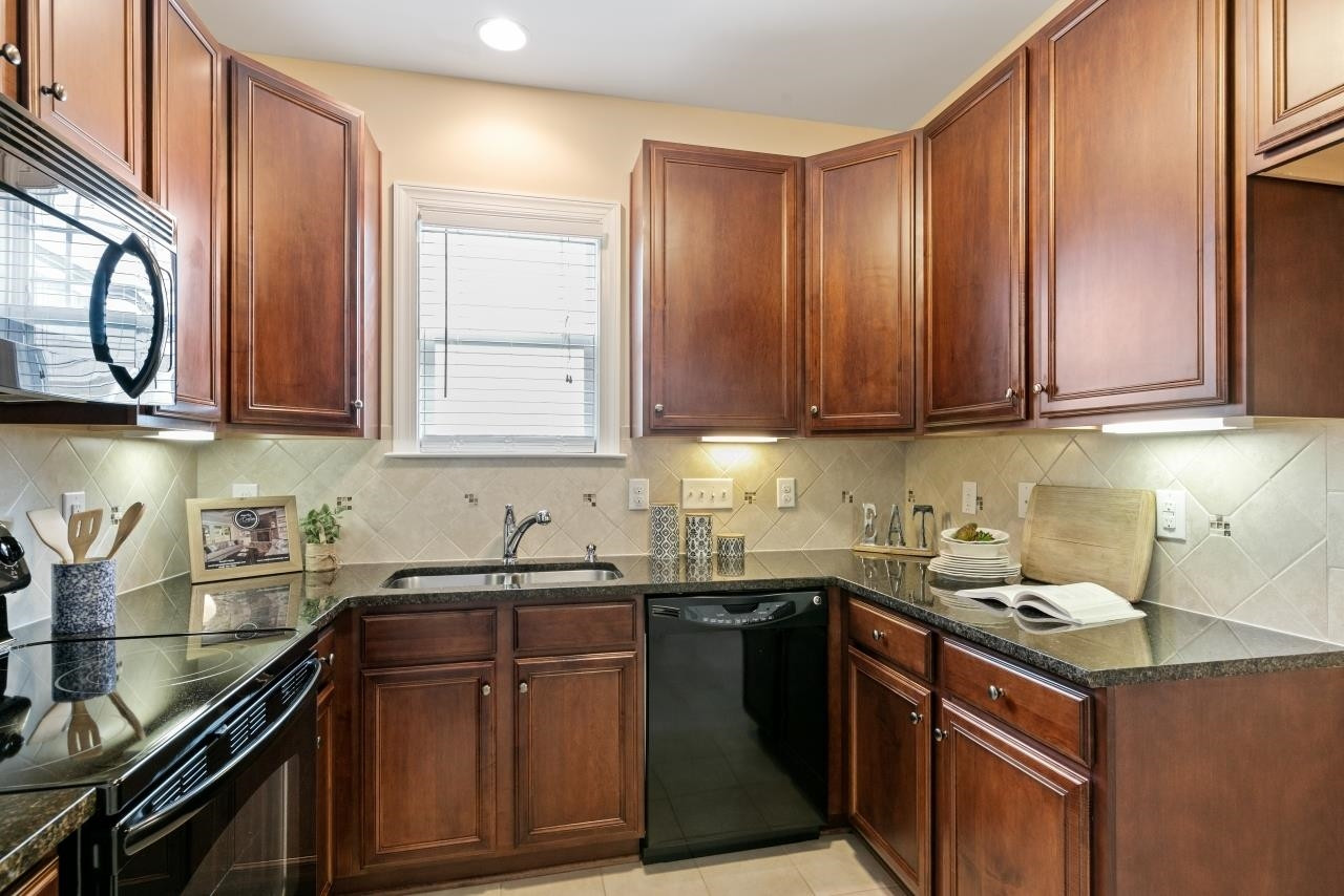 1909 Fieldhouse Avenue Raleigh, NC 27603 - Photo 8 of 32 Upgraded Cabinetry ~ Under Cabinet Lighting ~ Tile Backsplash