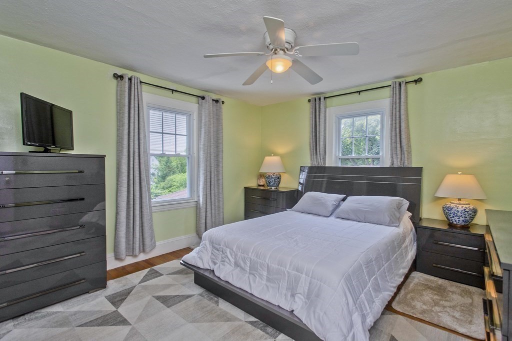 94 Gillette Avenue Springfield, MA 01118 - Photo 23 of 31 a bedroom with a bed and a flat tv screen