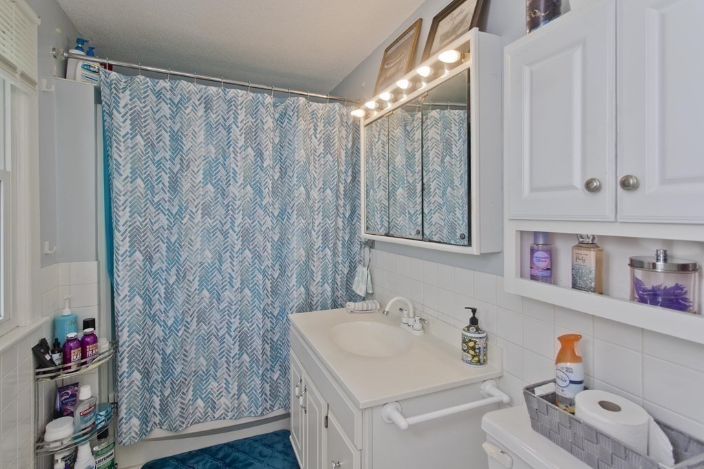 94 Gillette Avenue Springfield, MA 01118 - Photo 28 of 31 a bathroom with a sink and a shower curtain
