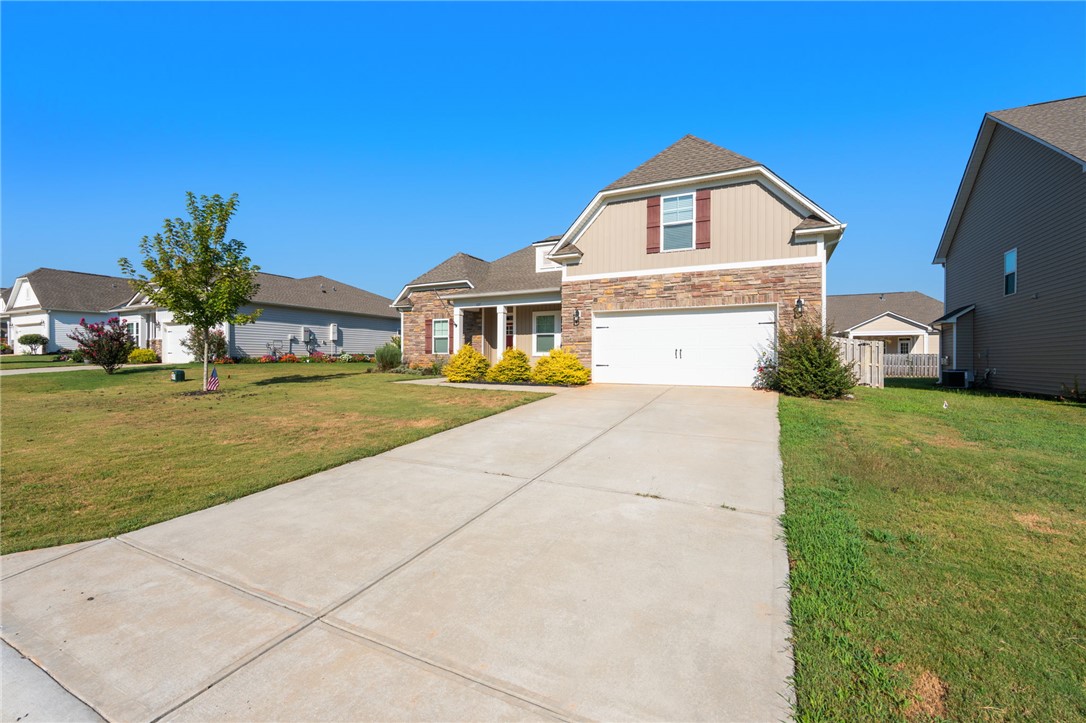 127 Spyglass Lane Pendleton, SC 29670 - Photo 7 of 45 A spacious concrete driveway leads toward the charming brick and siding exterior of this modern home.