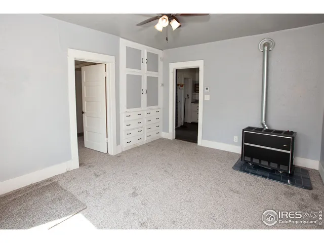 a view of kitchen with refrigerator and ceiling fan