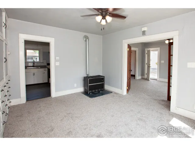 a dining room with furniture a rug and wooden floor