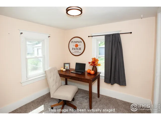 a view of a bedroom with a window and a cabinet