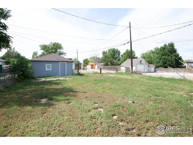 a house with huge green field in front of it
