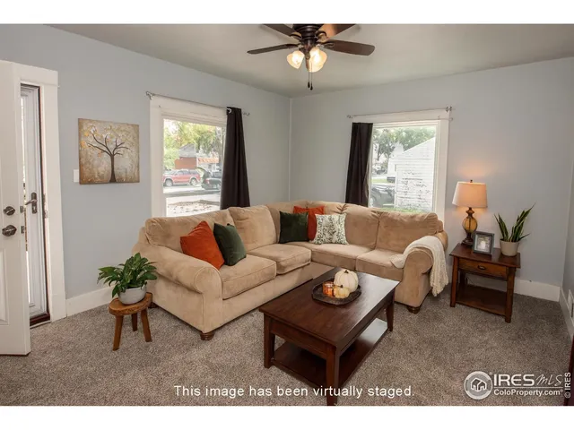 a living room with furniture a window and a chandelier