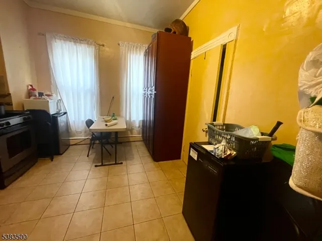 a living room with a table chair and a stove