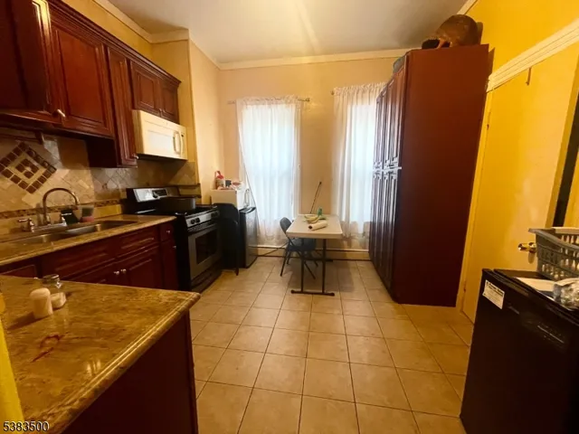 a kitchen with a sink and a refrigerator
