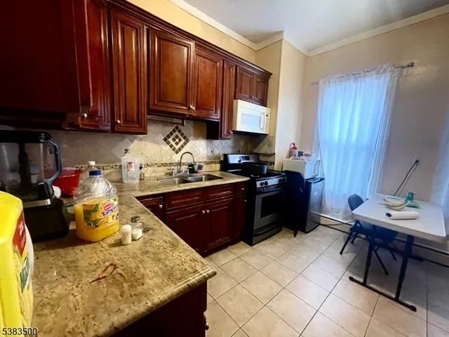 a kitchen with a refrigerator and a stove top oven