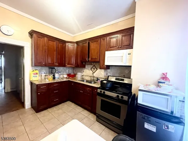 a kitchen with a sink stove and microwave